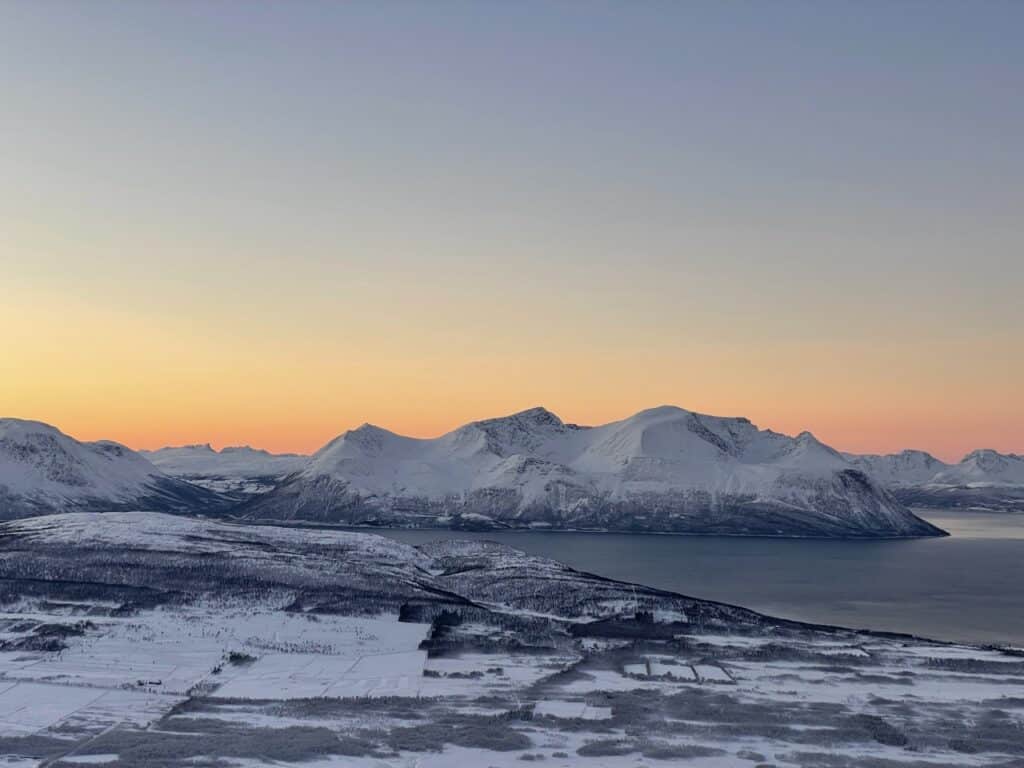 The mountains with the sunset behind it