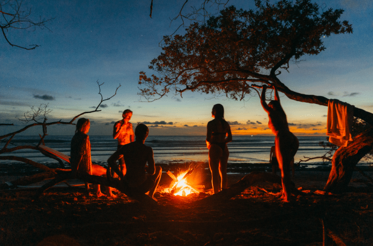 traveling solo but never by yourself - here with a camp fire on the beach